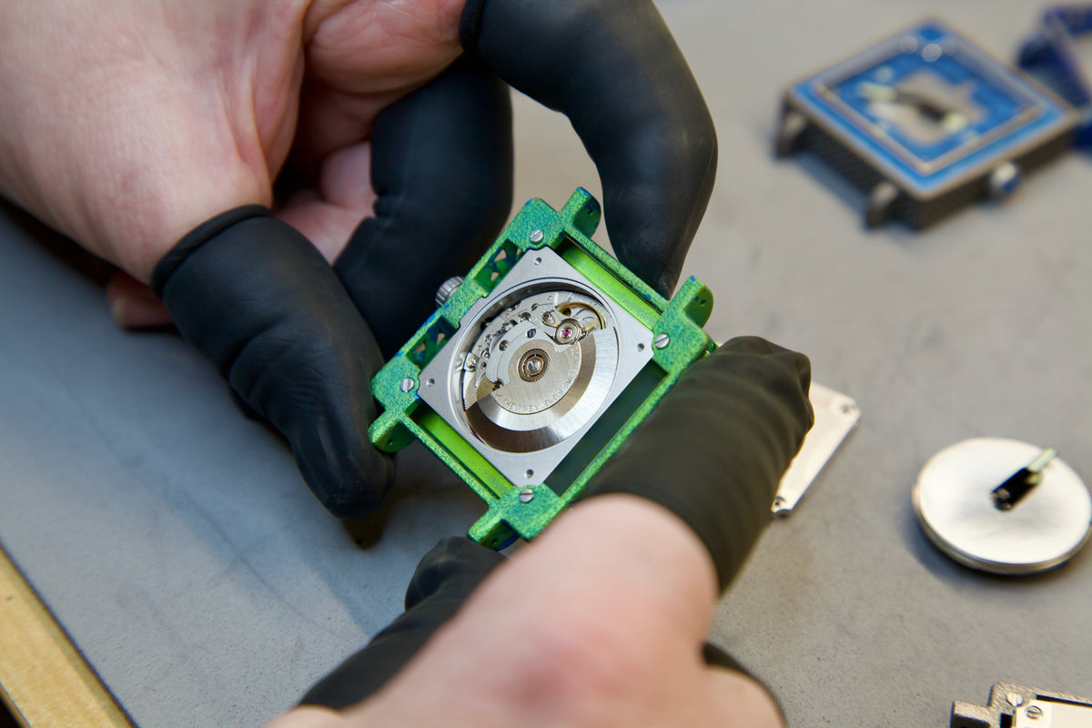 Plastic fit prints beside a finished titanium watch
